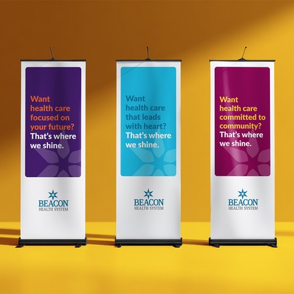Three vertical Beacon Health System banner stands with messages about future-focused, heart-led, and community-driven care.